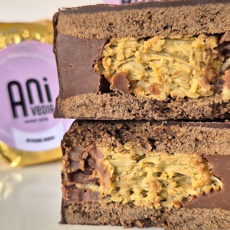 A close-up cross-section of a 'Dubai style' alfajor, revealing its intricate pistachio and chocolate layers, symbolizing the powerful impact of viral food trends on global supply chains.