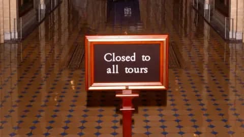 A 'Closed to all tours' sign in a US government building, symbolizing the uncertainty and potential peril facing the AGOA trade agreement.