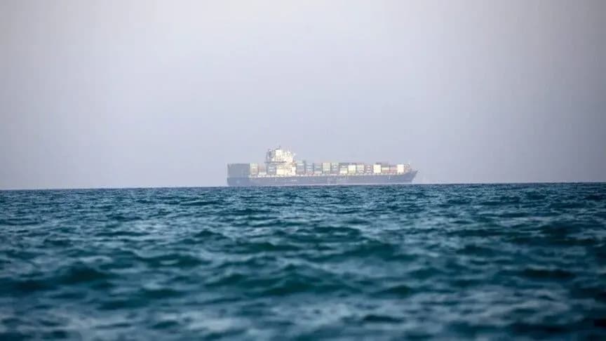 A container ship traveling through a maritime passage.