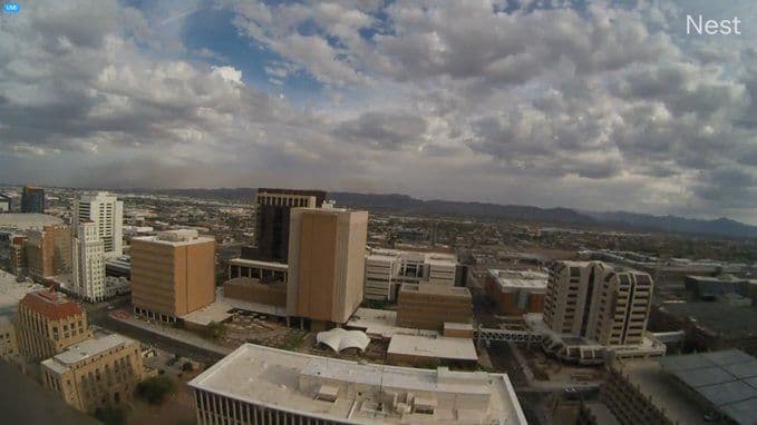 A large dust storm, or haboob, approaching or covering the city of Phoenix, illustrating the immediate impact of extreme weather.