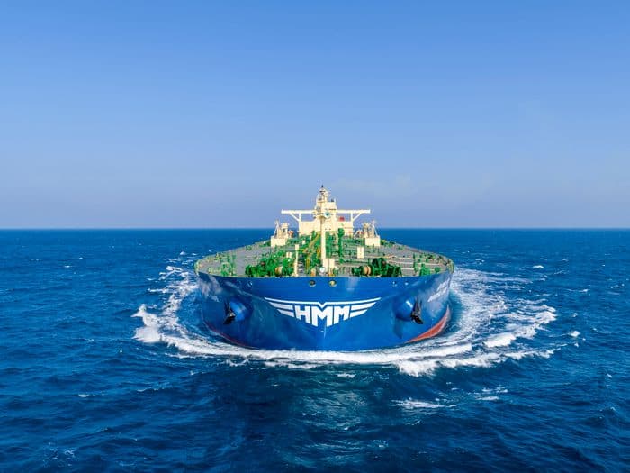 A large HMM bulk carrier ship on the open sea, symbolizing the company's new strategic direction for stable earnings.