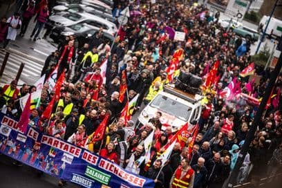 A large union procession with banners in Brest, symbolizing the collective action and unified voices striving to reclaim the protest narrative.