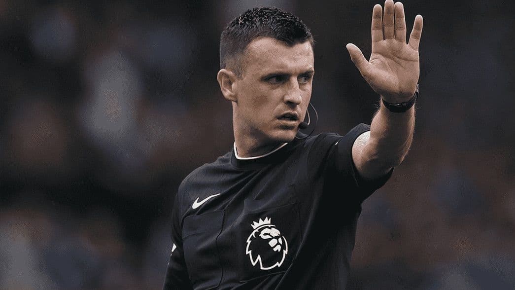 A Premier League referee signals, symbolizing new FPL rule changes and defensive points.