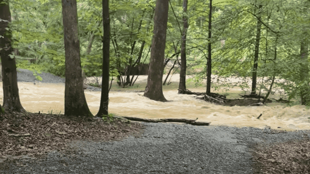 A residential driveway severely damaged and washed out by unexpected floodwaters in Montgomery County, Maryland.