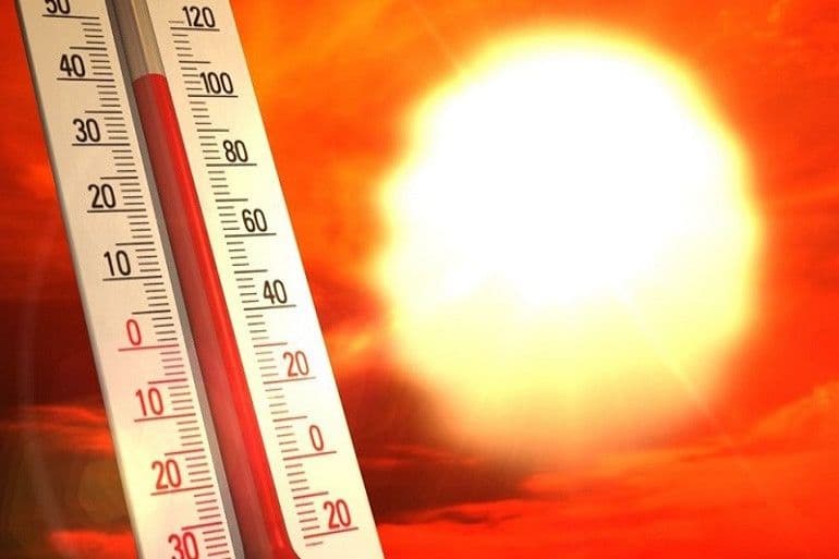 A thermometer showing high temperatures against a bright, hot sun, symbolizing Tunisia's summer heatwave.
