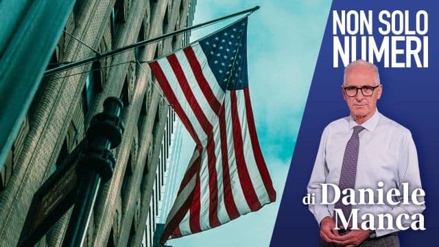 American flag on a building with a financial expert, symbolizing the complex impact of US tariffs.