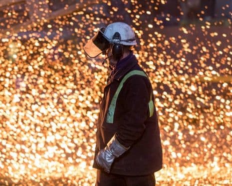 An industrial worker surrounded by a shower of fiery sparks, representing the challenging and uncertain future of Britain's steel industry.