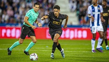 Andre Almeida, a midfielder, in action on the football pitch.