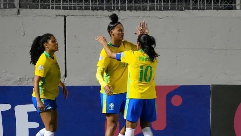 Brazilian women's football players celebrating a goal during a high-stakes match