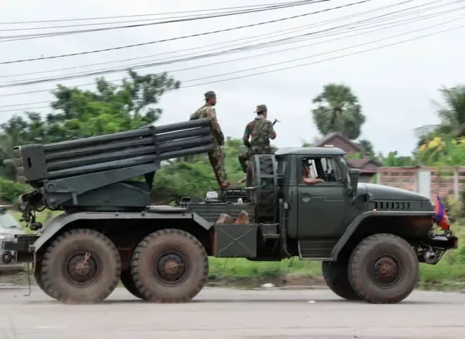 Cambodian soldiers on a self-propelled multiple rocket launcher during border clashes, highlighting the volatile regional security landscape impacting US-Thai relations.