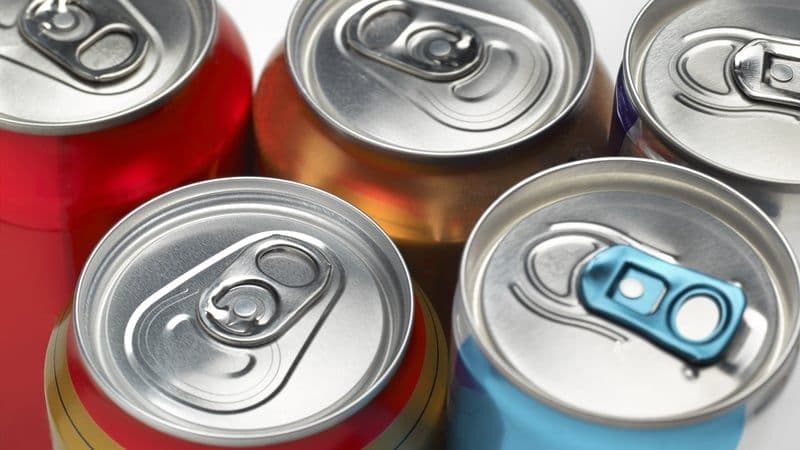 Close-up of colorful beverage cans, symbolizing the high cost of drinks and supermarket sticker shock in Ireland.