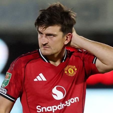 Dejected Harry Maguire in a Manchester United kit after a disappointing match