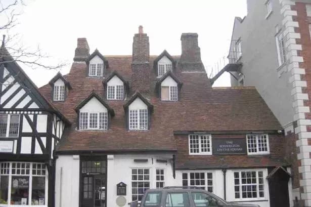 Exterior view of a traditional pub building, representing local establishments where craft cider was sold.