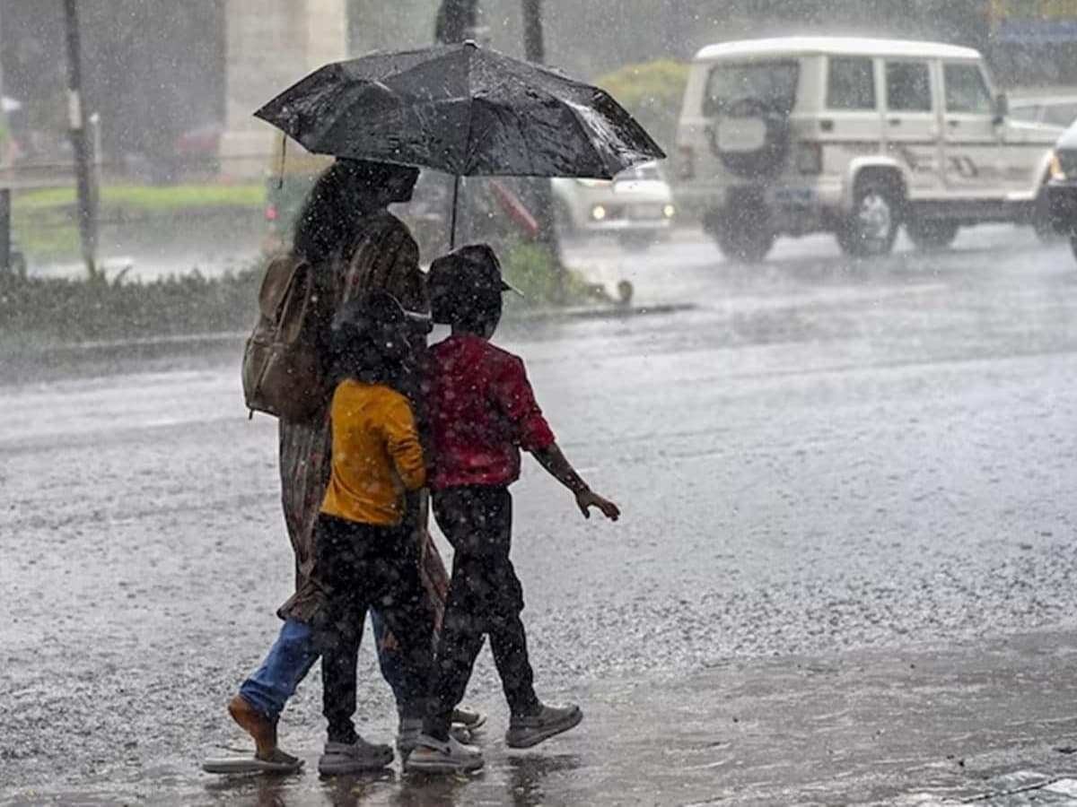 Family walking through heavy monsoon rain with an umbrella in Uttar Pradesh, demonstrating daily life and community navigation during the flood crisis.