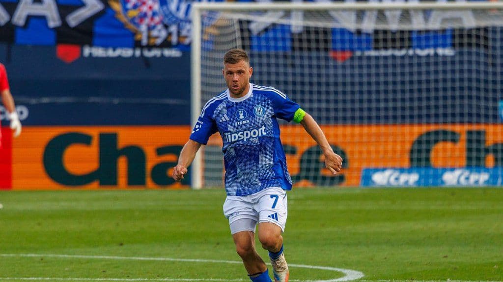 Football player in a blue Chance Liga jersey with Tipsport sponsor logo on the field, representing the unpredictable nature of the league.