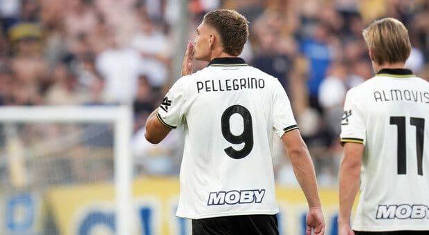 Football player Mateo Pellegrino celebrating a goal, wearing a white jersey with number 9.
