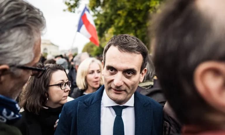 French politician Florian Philippot in a crowd, symbolizing ongoing political scrutiny and public engagement.