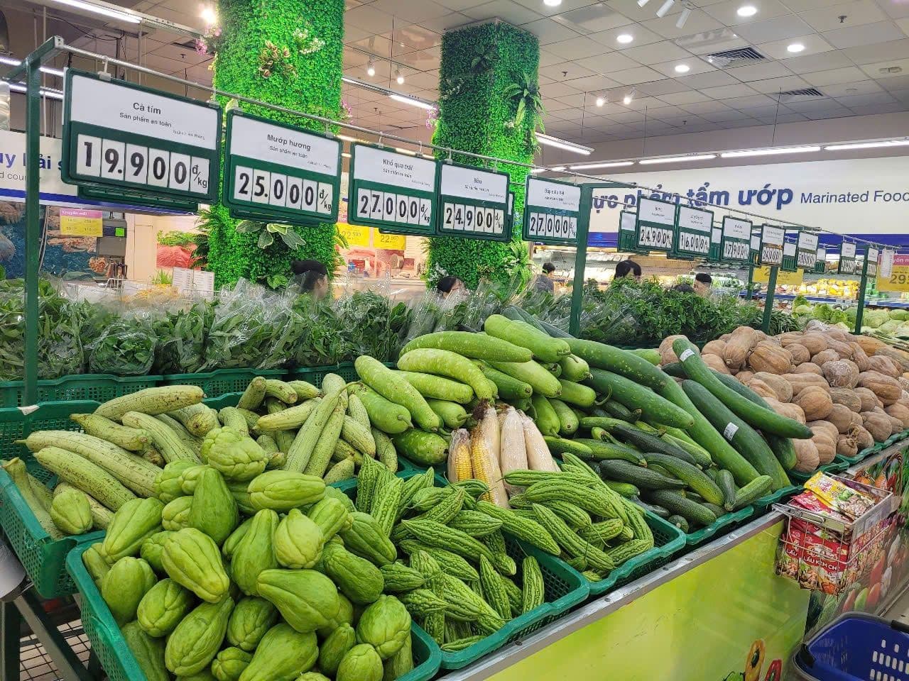 Fresh produce and price tags in a Vietnamese supermarket, illustrating the rising cost of living.
