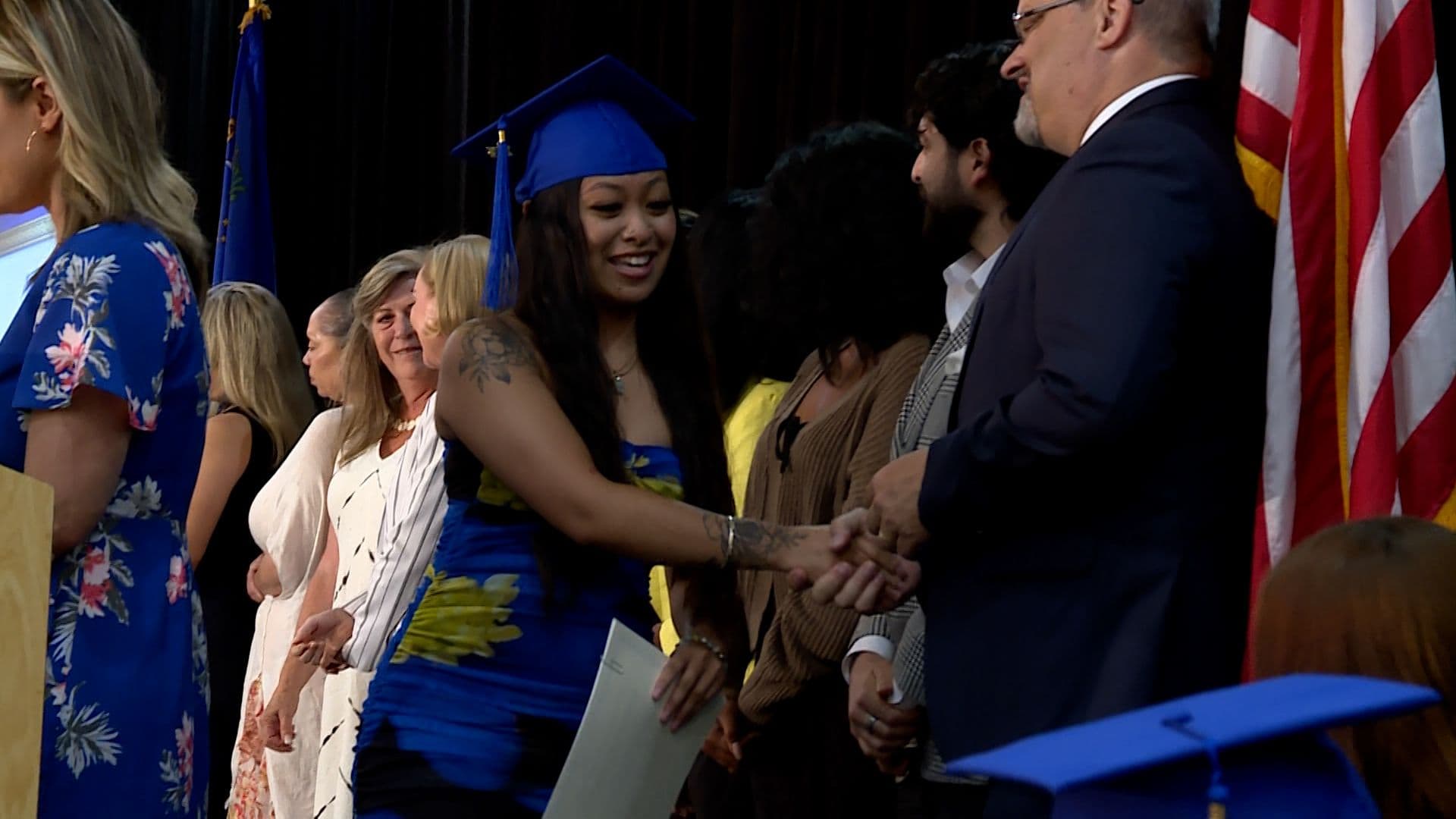 Graduates celebrating at a workforce training program ceremony, symbolizing community adaptation and skill development