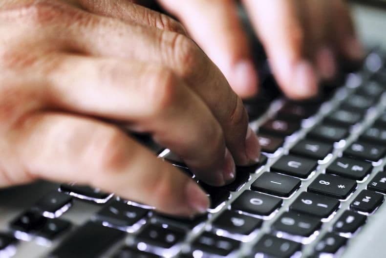 Hands typing on a laptop keyboard, symbolizing the digital footprint and forensic investigation in the Barne Estate legal battle.