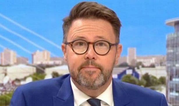 Jon Kay, a BBC Breakfast presenter, on screen relaying urgent weather alerts for Storm Floris.