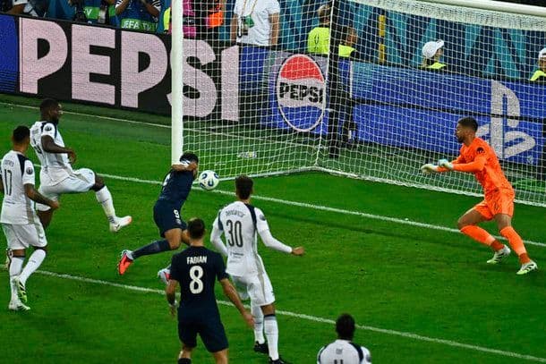 Lee Kang-in of Paris Saint-Germain proudly holding the UEFA Super Cup trophy.