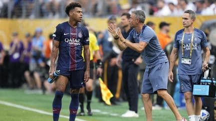 Luis Enrique et un joueur du PSG sur le terrain, symbolisant la quête de continuité après le succès européen.