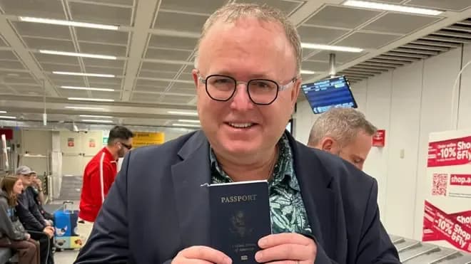 L'universitaire américain Paul Chambers tenant son passeport, faisant référence à l'affaire diplomatique mentionnée dans les négociations.