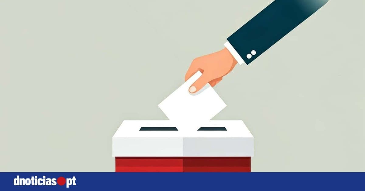 Mão a depositar voto em urna eleitoral, simbolizando o ato de votar e a integridade eleitoral.