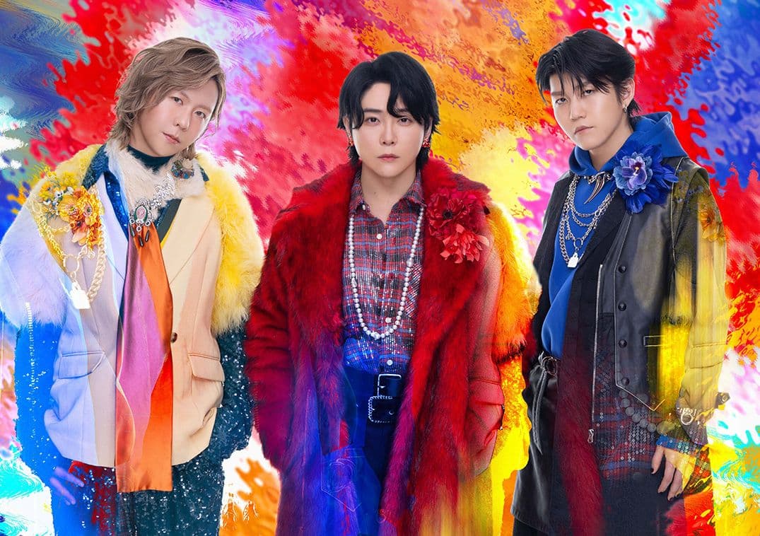 Mrs. GREEN APPLE band members in vibrant, artistic attire against a colorful background, representing their diverse musical style.