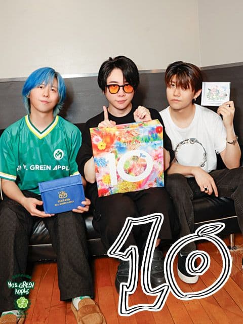Mrs. GREEN APPLE members celebrating their 10th anniversary, symbolizing their artistic journey and upcoming best album.