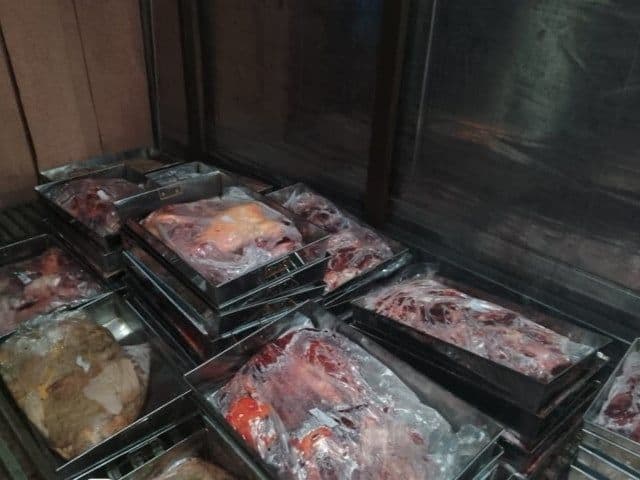 Packaged illicit meat in metal trays, likely prepared for distribution and sale, highlighting the profitability of the illegal trade.