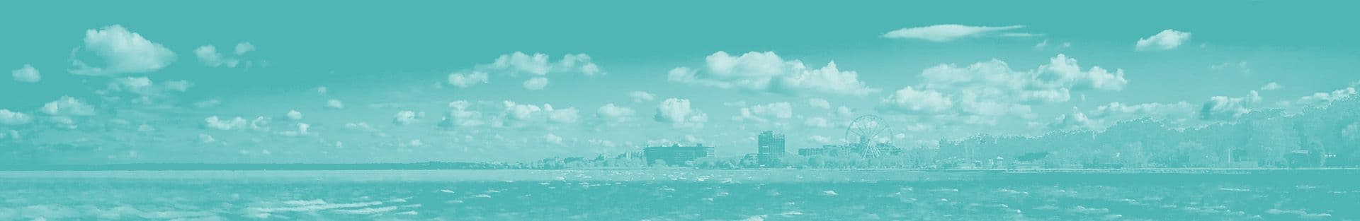 Panoramic view of Siófok city skyline along Lake Balaton under a cloudy sky, illustrating the typical summer destination.