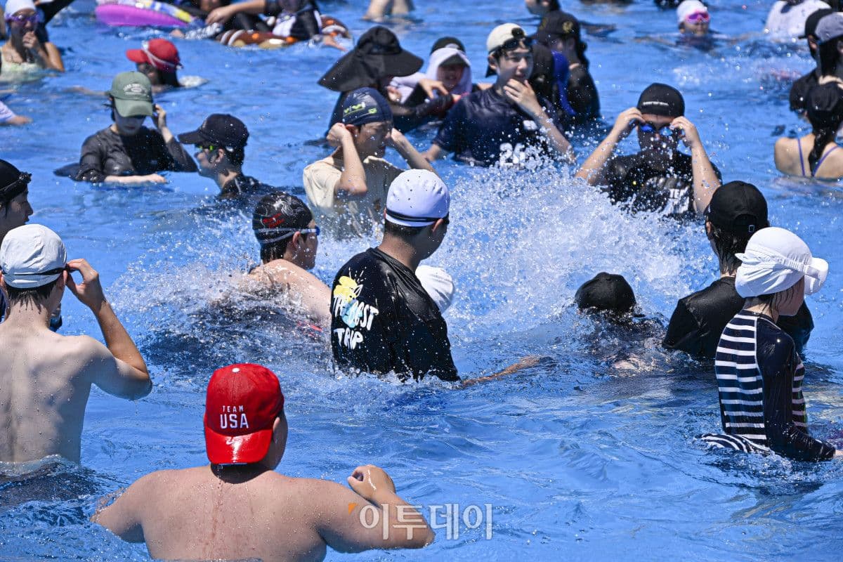 People cool off in a crowded outdoor swimming pool in Seoul during Korea's historic heatwave.