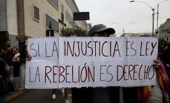 Peruvian protester holding a sign that reads 'If injustice is law, rebellion is a right' during demonstrations against pension reform.