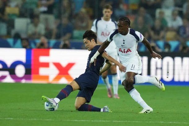 PSG's Lee Kang-in in a tackle with a Tottenham Hotspur player during the UEFA Super Cup match.