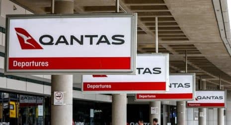 Qantas airport signage indicating departures, representing airline loyalty programs.