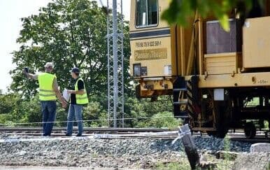 Railway workers and maintenance vehicle at the site of the fatal accident in Oriovac.