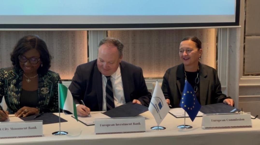 Representatives from First City Monument Bank and the European Investment Bank sign an agreement for a new agricultural financing facility.