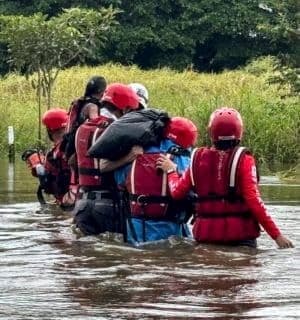 Rescue workers or residents wading through floodwaters in Guatuso, Costa Rica, during a recent deluge.