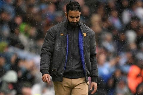 Ruben Amorim, Manchester United manager, looking dejected on the pitch amidst the club's crisis.