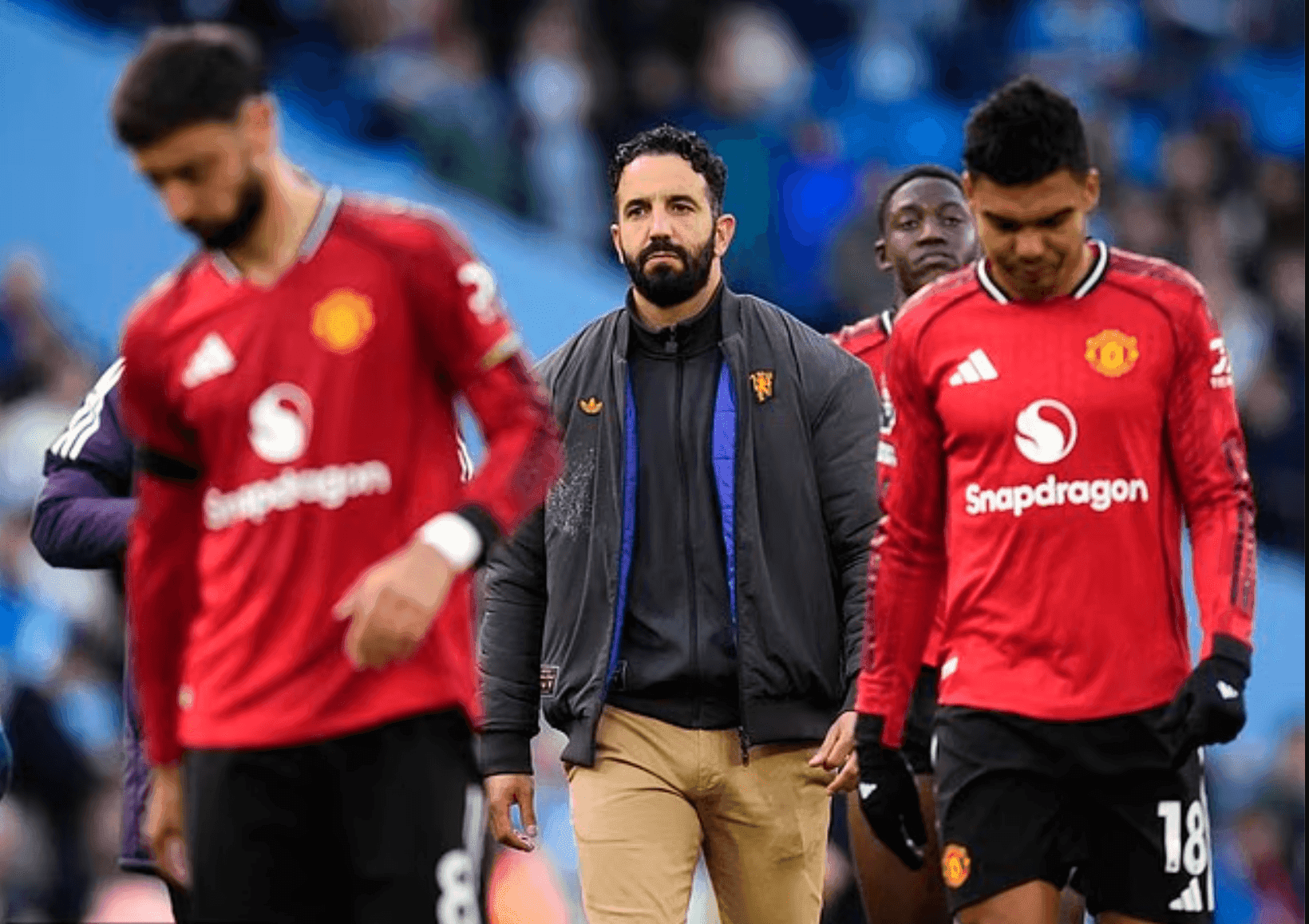 Ruben Amorim walking with dejected Manchester United players, symbolizing the club's £13 million compensation dilemma.