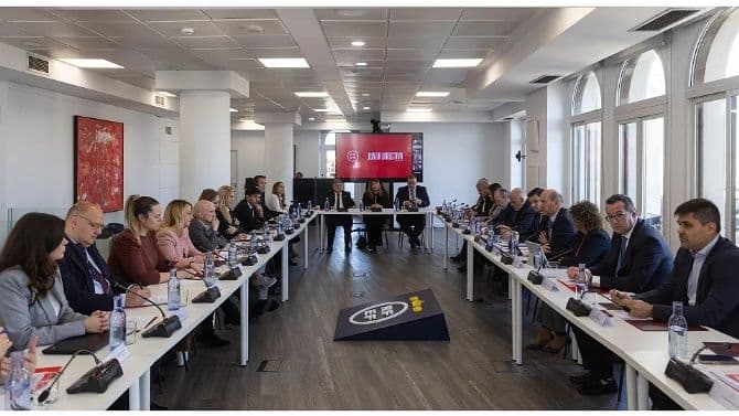 Réunion de dirigeants du football, illustrant les défis réglementaires et la gouvernance des compétitions.