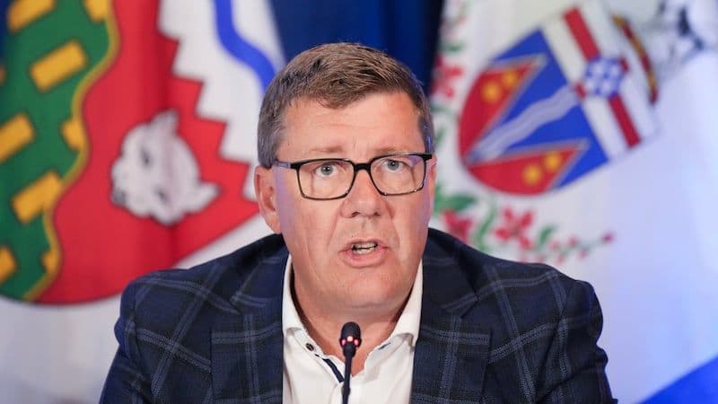 Saskatchewan Premier and industry leaders at a podium, highlighting tariff concerns and Canada's response.