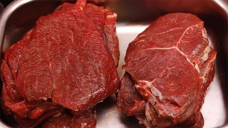 Seized donkey meat, suspected to be over 900 kilograms, displayed in a metal tray after a raid in Tarnol, Islamabad.