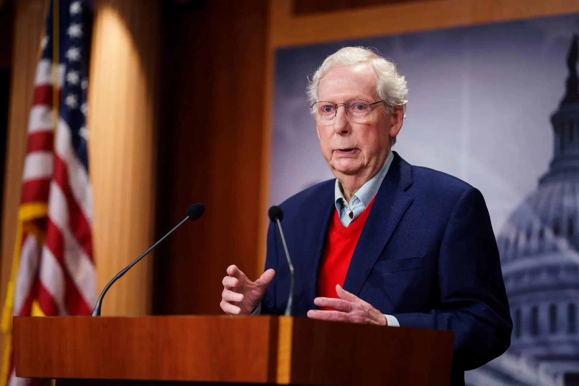 Senate Minority Leader Mitch McConnell speaks at a podium in the Capitol, representing the bipartisan pushback against Trump-era tariffs.
