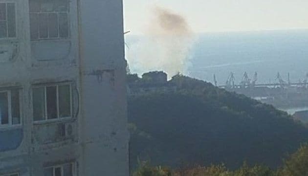 Smoke rising from an attack near Tuapse port on Russia's Black Sea coast, with port cranes visible in the background.