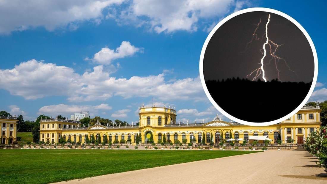 Sommerlicher Himmel über Kassel mit einem Blitzsymbol, das auf das bevorstehende Unwetter hinweist.