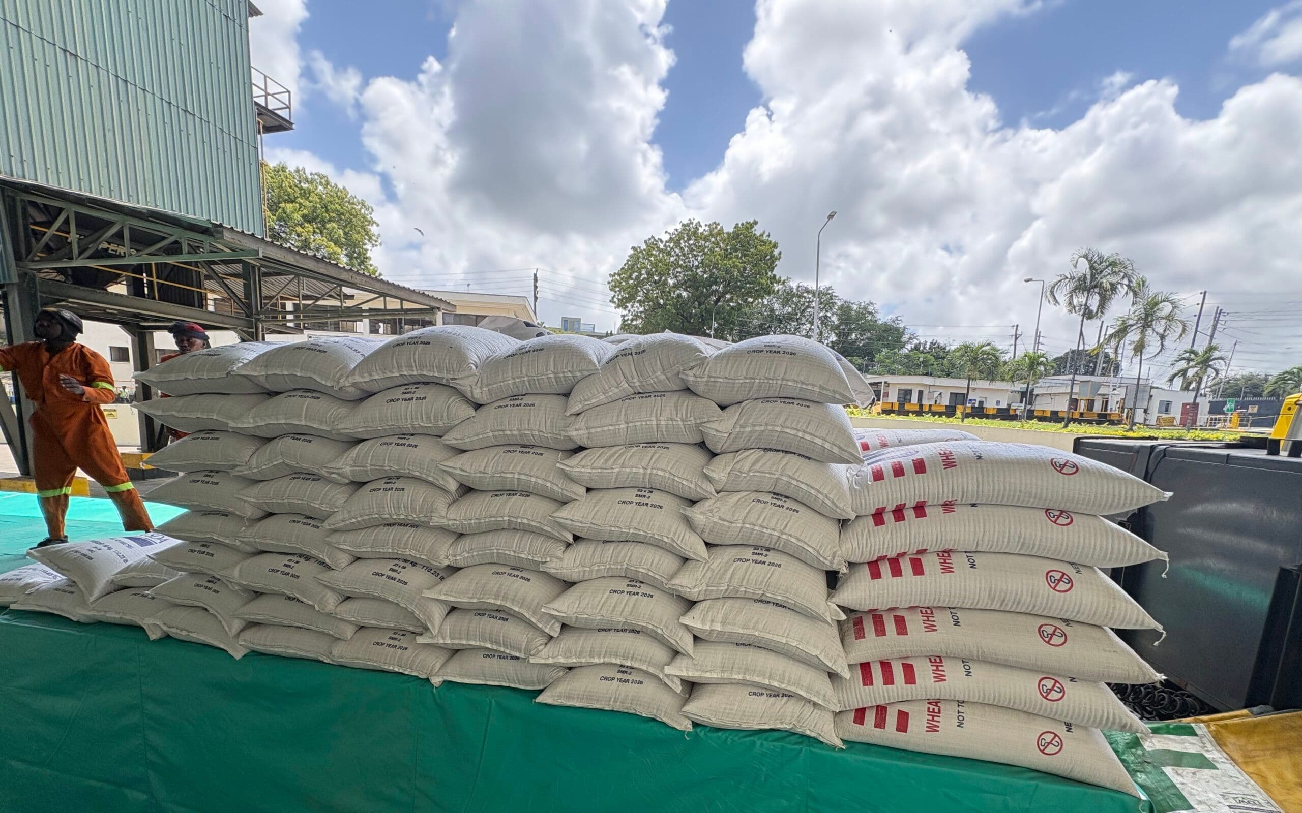 Stacked bags of U.S.-grown agricultural commodities awaiting transport for humanitarian aid distribution.