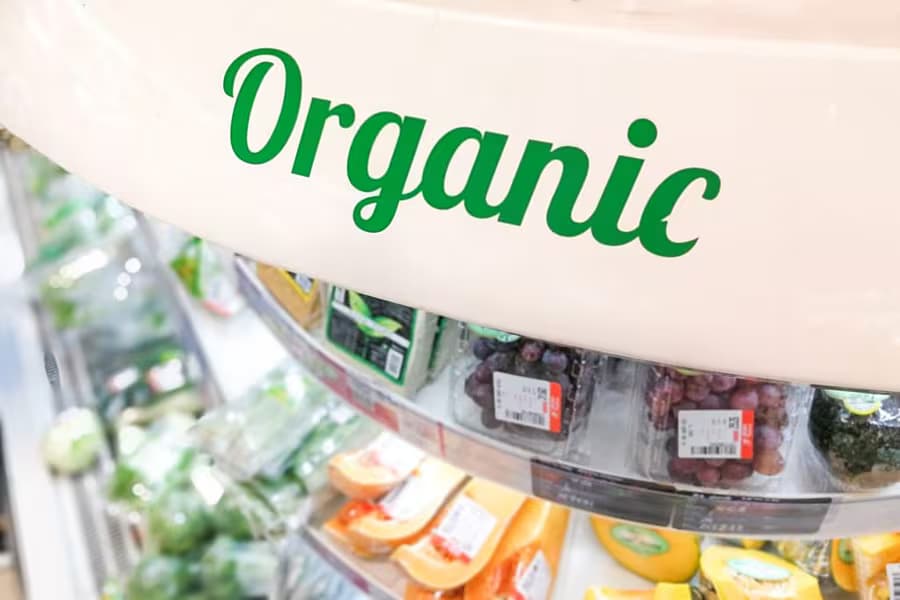 Supermarket shelf signage for organic produce representing the scope of EU organic regulations.